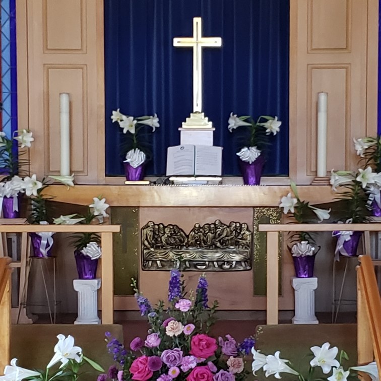 Interior of the church at a decorated altar/communion area, cropped to square.