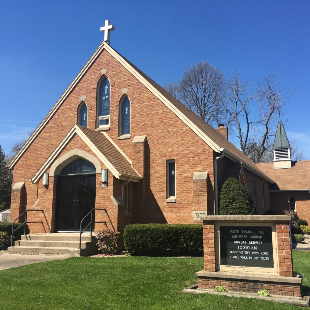 Exterior picture of Faith Evangelical Lutheran Church, right side, showing the church and its letterboard sign.